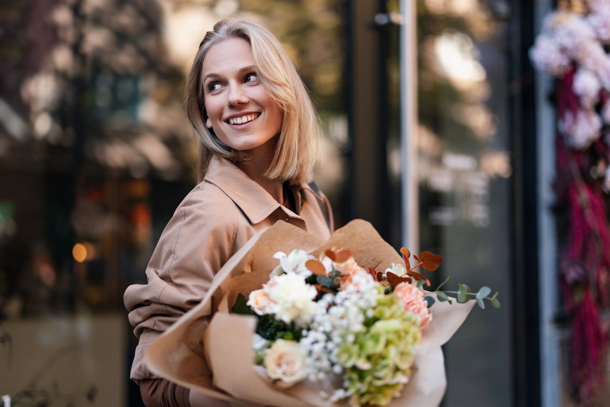 Woman holding a colorful bouquet outdoors