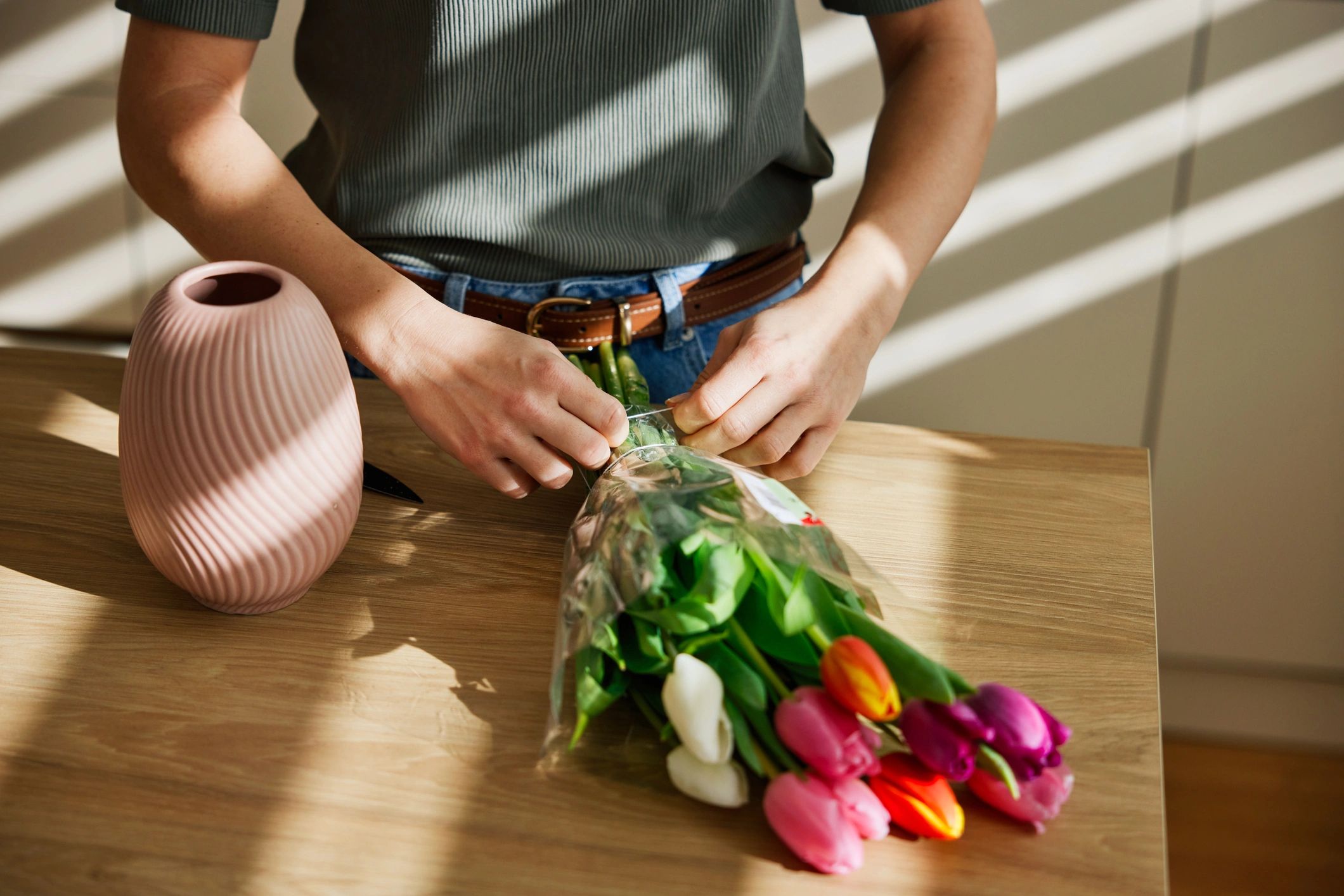Florist arranging a colorful bouquet on a table