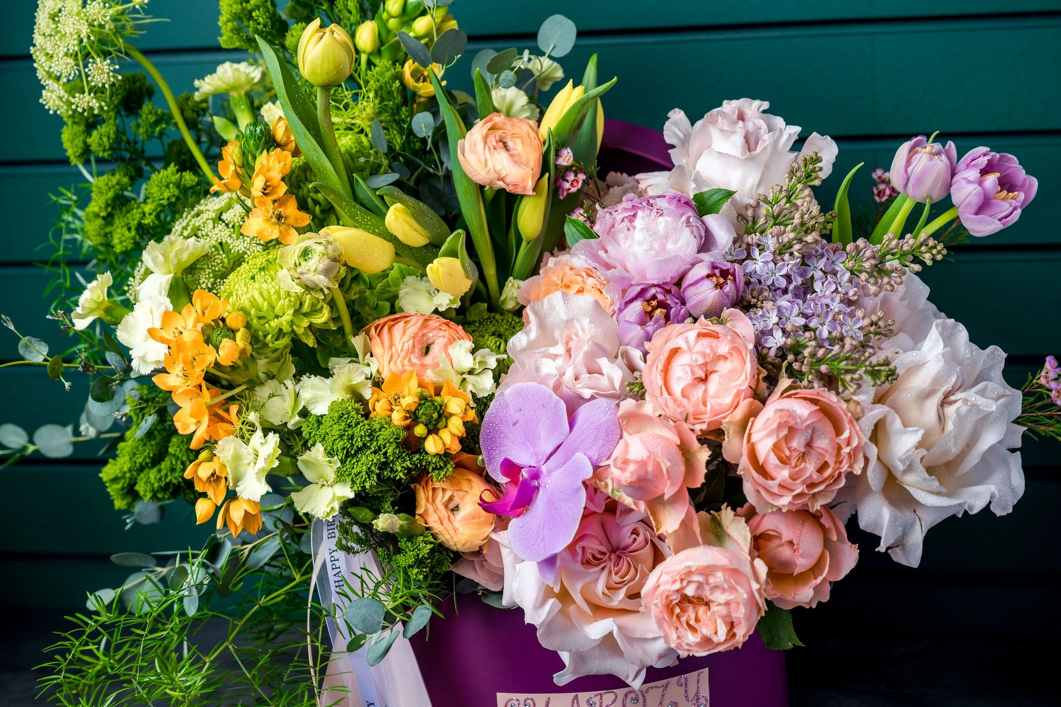 Large colorful flower bouquet in purple box