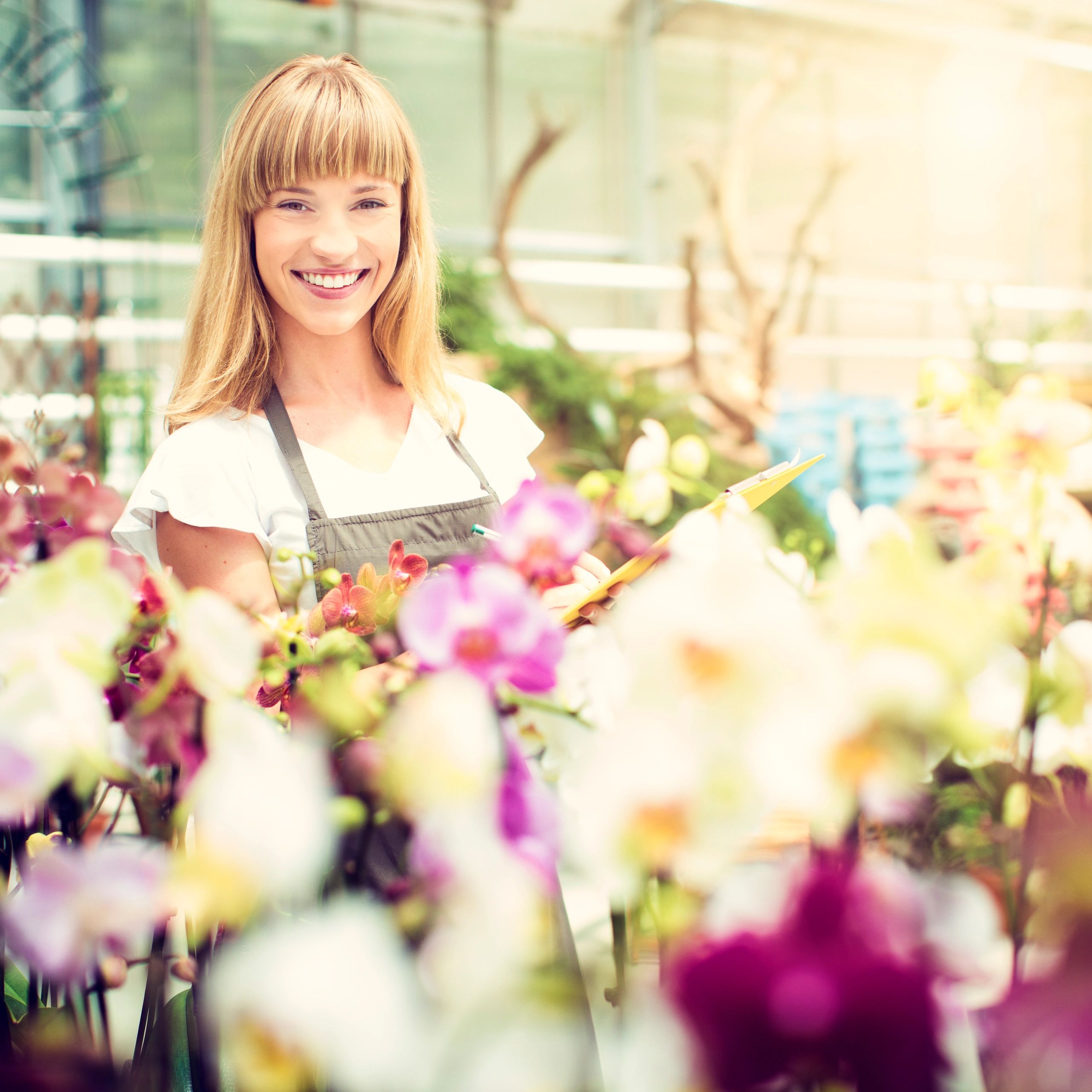 Female florist working among flowers